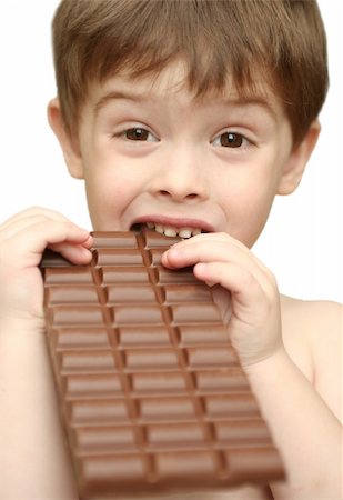 The boy bites a chocolate tile Stockbilder - Microstock & Abonnement, Bildnummer: 400-03916761