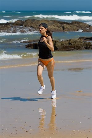 Athletic model running fast on the beach Stock Photo - Budget Royalty-Free & Subscription, Code: 400-03917643