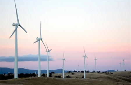 Wind generators line the hilltops on a modern wind farm. Foto de stock - Super Valor sin royalties y Suscripción, Código: 400-03917792