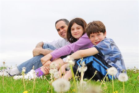 simsearch:6115-06732903,k - Portrait of a happy family of three on green grass Stock Photo - Budget Royalty-Free & Subscription, Code: 400-03919514