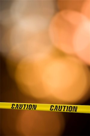 simsearch:600-02038306,k - Yellow tape with the word caution on it across a warning light background Photographie de stock - Aubaine LD & Abonnement, Code: 400-03919692