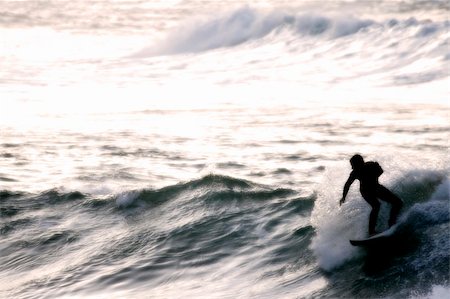 simsearch:400-03916559,k - Surfer silhouetted through sea mist just after sunset Photographie de stock - Aubaine LD & Abonnement, Code: 400-03910855