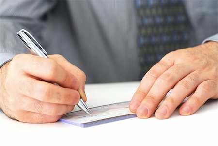 Closeup of man's hands writing a cheque Stock Photo - Budget Royalty-Free & Subscription, Code: 400-03911219