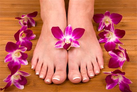 smelling feet - Spa treatment with fresh beautiful orchids Stock Photo - Budget Royalty-Free & Subscription, Code: 400-03911481