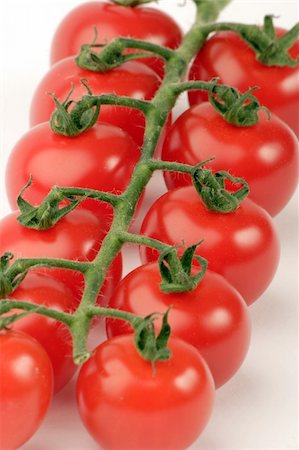 simsearch:400-03939080,k - Cherry Tomato's against a plain background Foto de stock - Super Valor sin royalties y Suscripción, Código: 400-03912129