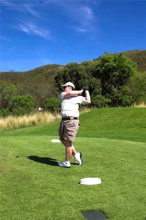 simsearch:400-04942072,k - Golfer swinging the golf club. Club is in motion. Foto de stock - Royalty-Free Super Valor e Assinatura, Número: 400-03912171