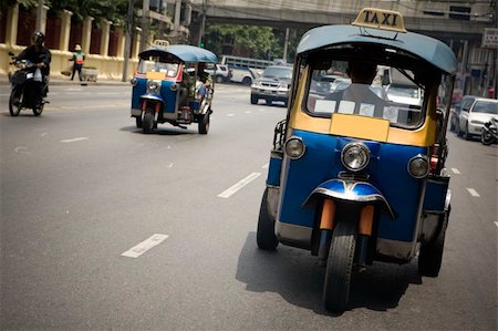 Tuk-tuk (cab) speeding on the street. Picture taken in Bangkok / Thailand Stock Photo - Budget Royalty-Free & Subscription, Code: 400-03912249