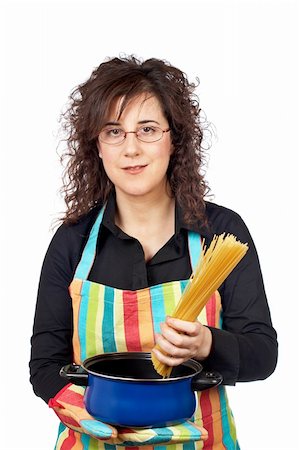 Housewife in apron who introduces a spaghetti uncooked in the blue pan Stock Photo - Budget Royalty-Free & Subscription, Code: 400-03912289