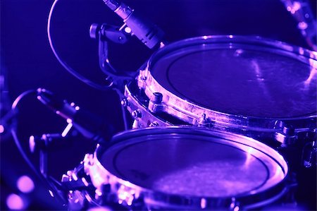 Rock concert series: drum set with microphones, lit by purple and blue Stock Photo - Budget Royalty-Free & Subscription, Code: 400-03912568