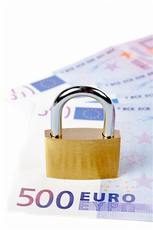 simsearch:693-06021301,k - Locked padlock and money over a white background Stock Photo - Budget Royalty-Free & Subscription, Code: 400-03912695