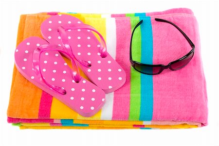 Colorful summer beachwear (flipflops), towel, and sunglasses Foto de stock - Super Valor sin royalties y Suscripción, Código: 400-03913907