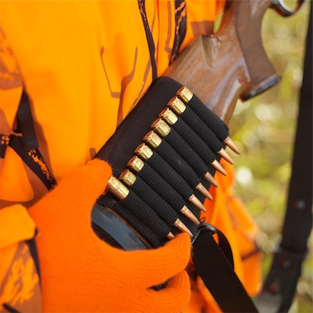 Close-up of hunter removing bullet from ammo holder on rifle. Stock Photo - Budget Royalty-Free & Subscription, Code: 400-03924064