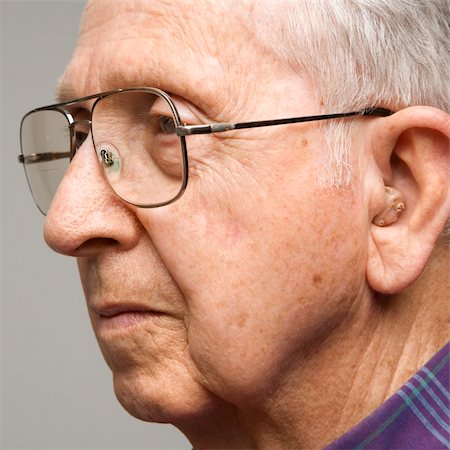 Close-up profile portrait of Caucasion elderly man with glasses and hearing aid. Stock Photo - Budget Royalty-Free & Subscription, Code: 400-03924222