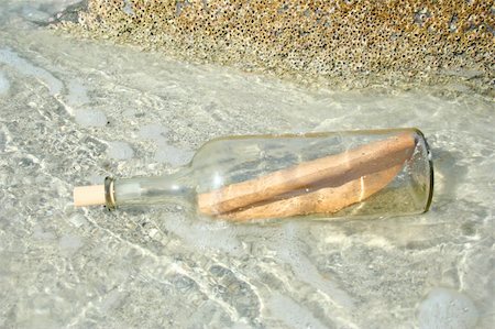 Message in a bottle reaching the rocky coast Stock Photo - Budget Royalty-Free & Subscription, Code: 400-03924262