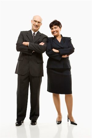 filipina businesswoman - Smiling Caucasian middle-aged businessman and Filipino businesswoman standing  with arms crossed against white background. Stock Photo - Budget Royalty-Free & Subscription, Code: 400-03924347