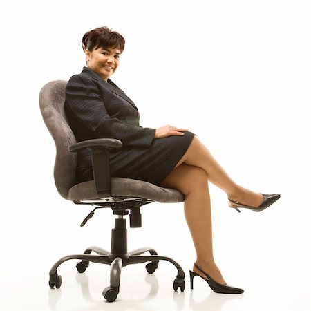 filipina businesswoman - Filipino middle-aged businesswoman sitting in office chair against white background. Stock Photo - Budget Royalty-Free & Subscription, Code: 400-03924342