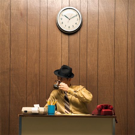 retro men drinking - Caucasion mid-adult retro businessman wearing fedora sitting at desk drinking coffee. Stock Photo - Budget Royalty-Free & Subscription, Code: 400-03924424