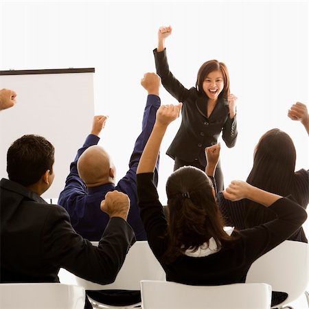 sprecherin - Vietnamese mid-adult woman standing in front of cheering business group during a presentation. Stockbilder - Microstock & Abonnement, Bildnummer: 400-03924423