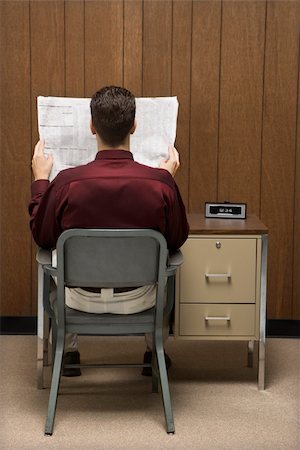 Back view of retro businessman sitting at desk reading paper. Stock Photo - Budget Royalty-Free & Subscription, Code: 400-03924438