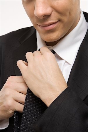 enderezando - Close-up of Claucasian mid-adult man straightening necktie. Foto de stock - Super Valor sin royalties y Suscripción, Código: 400-03924482
