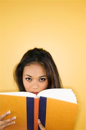 simsearch:400-03923096,k - Filipino young adult woman peering over book at viewer. Stock Photo - Budget Royalty-Free & Subscription, Code: 400-03924862