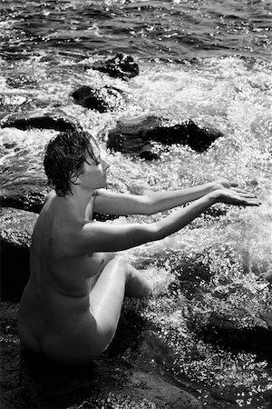 simsearch:400-04956611,k - Mid adult nude Caucasian woman sitting in water at Maui, Hawaii beach with arms outstretched. Photographie de stock - Aubaine LD & Abonnement, Code: 400-03925000