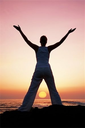 simsearch:400-04596923,k - Woman in meditation pose at sunset with falling sun Stock Photo - Budget Royalty-Free & Subscription, Code: 400-03925043