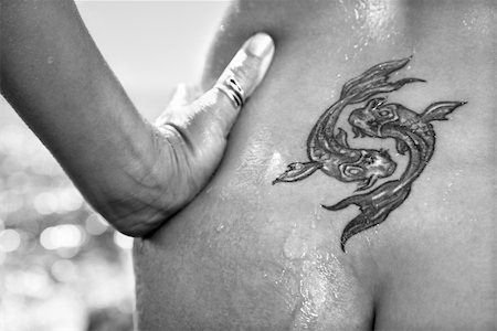 Close up of nude wet Caucasian mid adult womans tattoo of koi fish on lower back. Stock Photo - Budget Royalty-Free & Subscription, Code: 400-03925149
