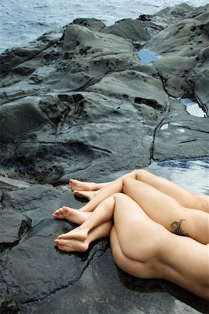 simsearch:400-04450899,k - Three nude Caucasian mid-adult women lying side by side on rocky beach in Maui, Hawaii. Stock Photo - Budget Royalty-Free & Subscription, Code: 400-03925173