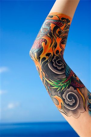 Close up of tattooed woman's arm with Pacific Ocean in background in Maui, Hawaii, USA. Stock Photo - Budget Royalty-Free & Subscription, Code: 400-03925184