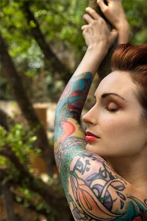 Nude tattooed Caucasian woman in forest leaning on tree in Maui, Hawaii, USA. Stock Photo - Budget Royalty-Free & Subscription, Code: 400-03925216