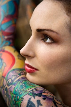 simsearch:400-04186416,k - Close-up of attractive Caucasian woman's face and tattooed arm. Stockbilder - Microstock & Abonnement, Bildnummer: 400-03925218