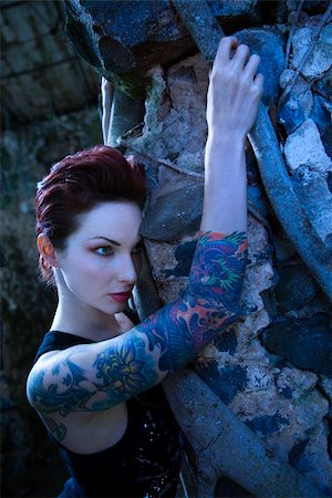 simsearch:400-04186416,k - Blue-toned portrait of fearful looking tattooed Caucasian woman next to concrete wall in Maui, Hawaii, USA. Stockbilder - Microstock & Abonnement, Bildnummer: 400-03925211