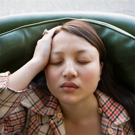 simsearch:400-03925541,k - Pretty young Asian woman sitting in green chair with eyes closed. Foto de stock - Super Valor sin royalties y Suscripción, Código: 400-03925551