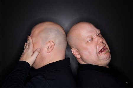 sibling sad - Caucasian bald mid adult identical twin  men standing back to back with sad expressions. Stock Photo - Budget Royalty-Free & Subscription, Code: 400-03925564