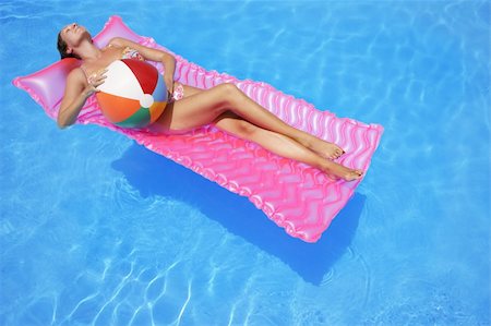 simsearch:400-04001385,k - Woman sunbathing on a lilo Stock Photo - Budget Royalty-Free & Subscription, Code: 400-03925597