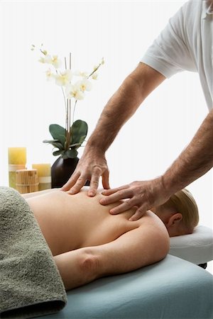 simsearch:400-04956215,k - Caucasian middle-aged male massage therapist massaging back of Caucasian middle-aged woman lying on massage table. Photographie de stock - Aubaine LD & Abonnement, Code: 400-03925694