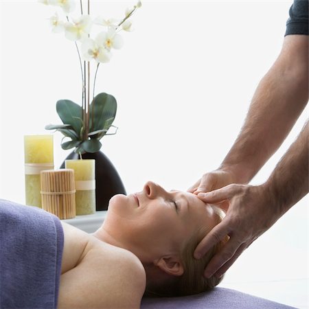 simsearch:400-05131187,k - Caucasian middle-aged male massage therapist massaging temples of Caucasian middle-aged woman lying on massage table. Stock Photo - Budget Royalty-Free & Subscription, Code: 400-03925692