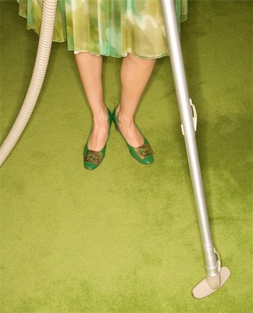 Close-up of Caucasian female legs with vacuum extension against green retro carpet. Stock Photo - Budget Royalty-Free & Subscription, Code: 400-03925739
