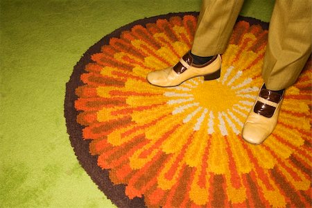 simsearch:400-04451365,k - Close-up of Caucasian mid-adult male feet in vintage shoes against sunburst rug. Foto de stock - Super Valor sin royalties y Suscripción, Código: 400-03925746