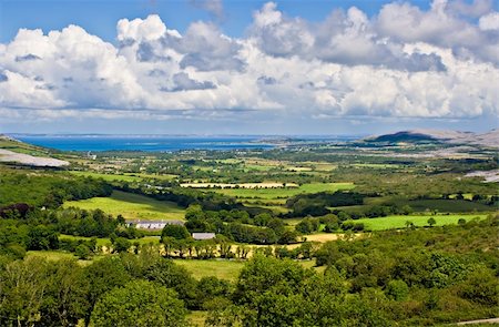 simsearch:400-08753717,k - Landscape of County Clare, Ireland. Green fields in foreground and Galway Bay in the background. Beginings of the Burren can also be seen. Foto de stock - Super Valor sin royalties y Suscripción, Código: 400-03925815