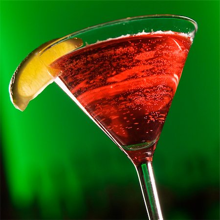 Still life of martini cocktail with  fruit garnish against glowing green background. Stock Photo - Budget Royalty-Free & Subscription, Code: 400-03926015