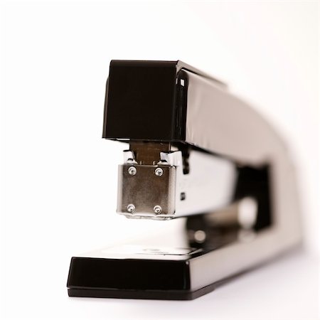 simsearch:400-03926032,k - Selective focus of black stapler on white background. Stock Photo - Budget Royalty-Free & Subscription, Code: 400-03926030