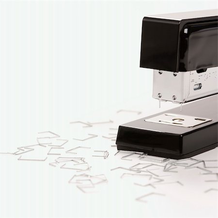 simsearch:400-03926032,k - Black stapler on white background surrounded by individual staples. Stock Photo - Budget Royalty-Free & Subscription, Code: 400-03926031