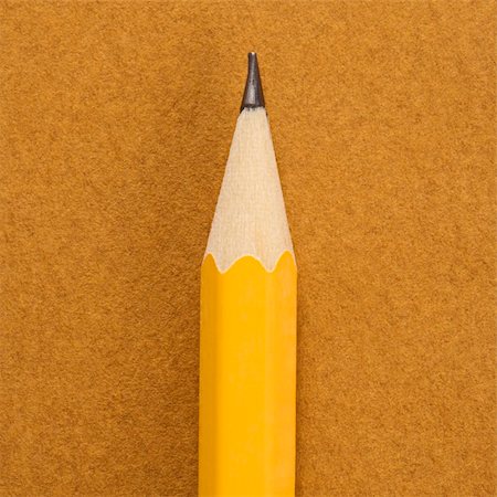 simsearch:400-05289294,k - Close up of sharp pencil tip on tan background. Photographie de stock - Aubaine LD & Abonnement, Code: 400-03926161