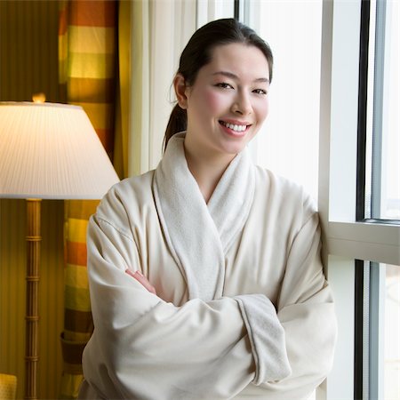 simsearch:400-03926201,k - Taiwanese mid adult woman in bathrobe smiling at viewer with arms crossed. Fotografie stock - Microstock e Abbonamento, Codice: 400-03926199