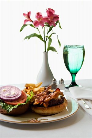 simsearch:689-03128122,k - Cheeseburger meal with flowers and glass of water. Stock Photo - Budget Royalty-Free & Subscription, Code: 400-03926206
