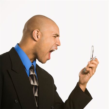 simsearch:400-03923064,k - Head and shoulder portrait of African American man in suit yelling at cellphone. Stock Photo - Budget Royalty-Free & Subscription, Code: 400-03926215