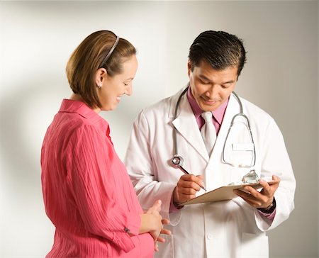 Asian American male doctor consulting with pregnant Caucasian woman. Stock Photo - Budget Royalty-Free & Subscription, Code: 400-03926257