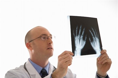 simsearch:400-05088220,k - Caucasian mid adult male physician holding up hand xrays. Stock Photo - Budget Royalty-Free & Subscription, Code: 400-03926379